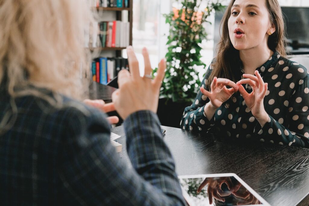 Two people using ASL